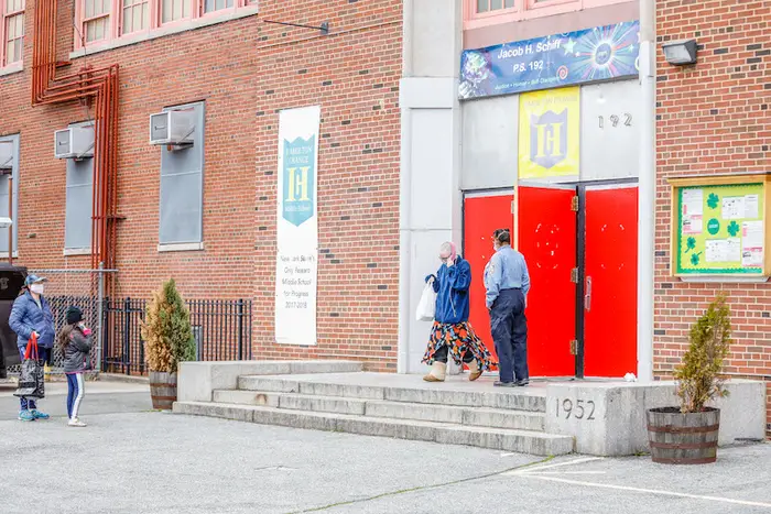 A photo of people walking in and out of PS 192 in Manhattanville.